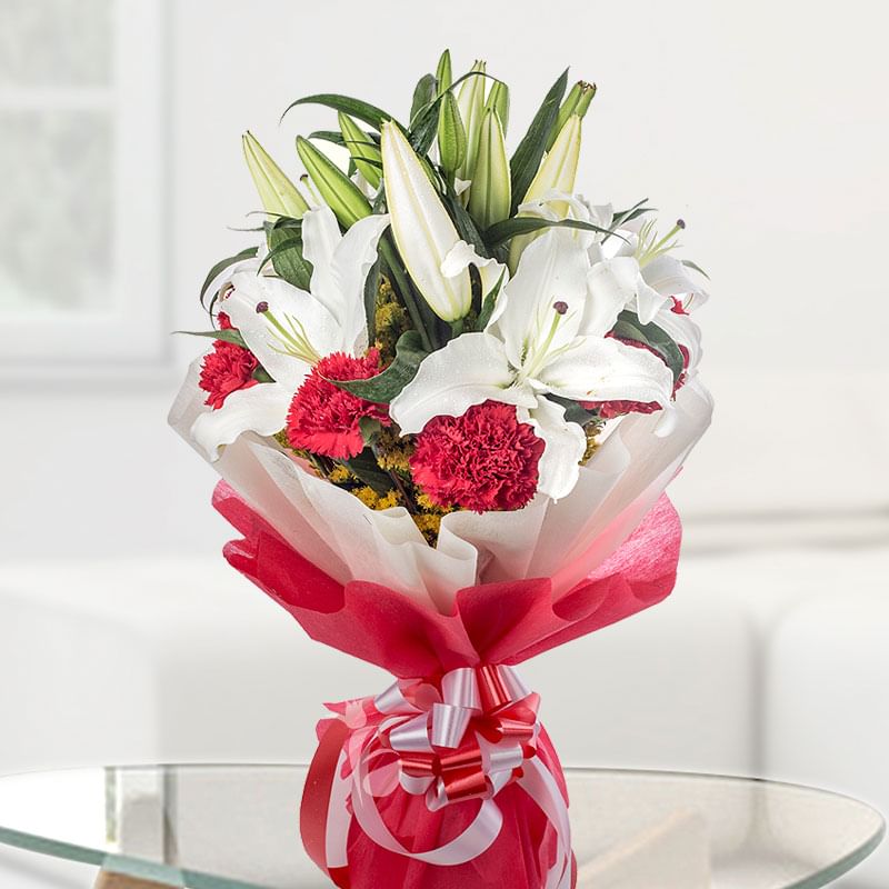 2 White Lilies and 12 Red Carnations on Table